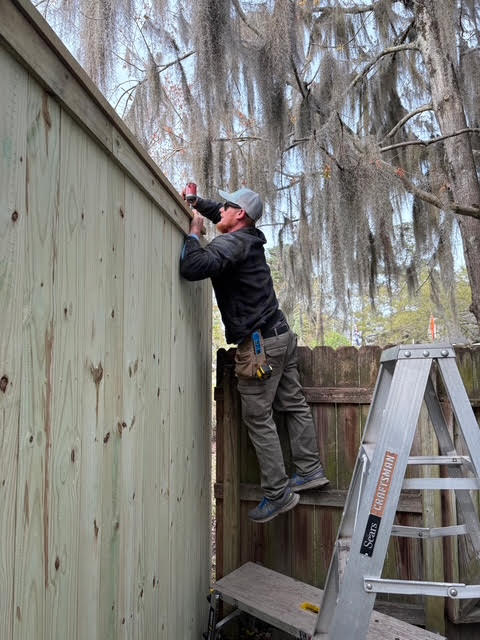 Ryan Gifford working on a fence installation in Charleston